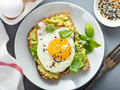 A plate of Avocado & Egg Toast for breakfast.