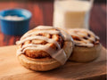 Soft & Buttery Cinnamon Roll served on a wooden chopping board.